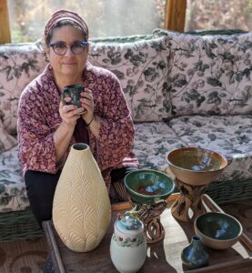 Our lovely, Rachel Durland, pictured with a variety of her stunningly handmade pottery!